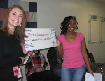 Rockisha Henderson, right, presents a check to Chantel Decker of the Transitions Program for Women at a ceremony at Pine Lodge Correction Center for Women last week.  (Lisa Leinberger / The Spokesman-Review)