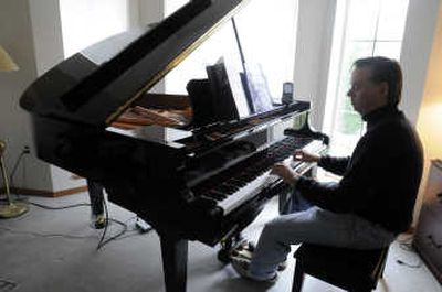 
Ron McIntire's Yamaha Disklavier, which houses myriad electronic features, plays a song from an file on the Internet.
 (Jesse Tinsley / The Spokesman-Review)