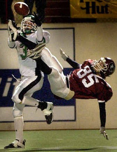 
EV wide receiver Grant Bruscoe goes high for a catch en route to a 44-yard scoring play over NC defensive back Mark Simpson. 
 (Brian Plonka/The Associated Press / The Spokesman-Review)