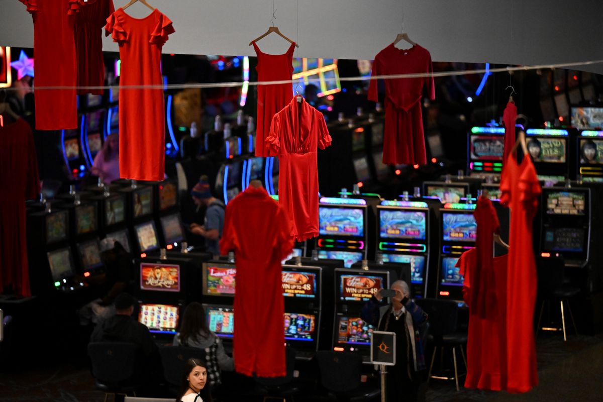 Red dresses symbolizing missing and murdered Indigenous women hang from the ceiling during a ceremony to bring awareness to the 60 Indigenous women missing in Washington State on Thursday, May 5, 2022, at Northern Quest Resort and Casino in Airway Heights, Wash.  (Tyler Tjomsland/The Spokesman-Review)