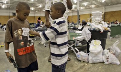 Children play inside a shelter set up for evacuees in Shreveport, La., on Tuesday. Many evacuees are complaining about sub-standard facilities devoid of any Red Cross or FEMA aid.  (Associated Press / The Spokesman-Review)