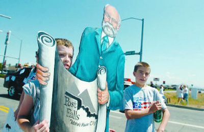 
Jobie Robbins, left, 12, carries a painted cutout of Frederick Post in the Post Falls Days parade Saturday. At right is Konnor Stellflug, 11. The image of Post Falls' founder is part of a local history project by students at Ponderosa Elementary in Post Falls. 
 (Jesse Tinsley / The Spokesman-Review)