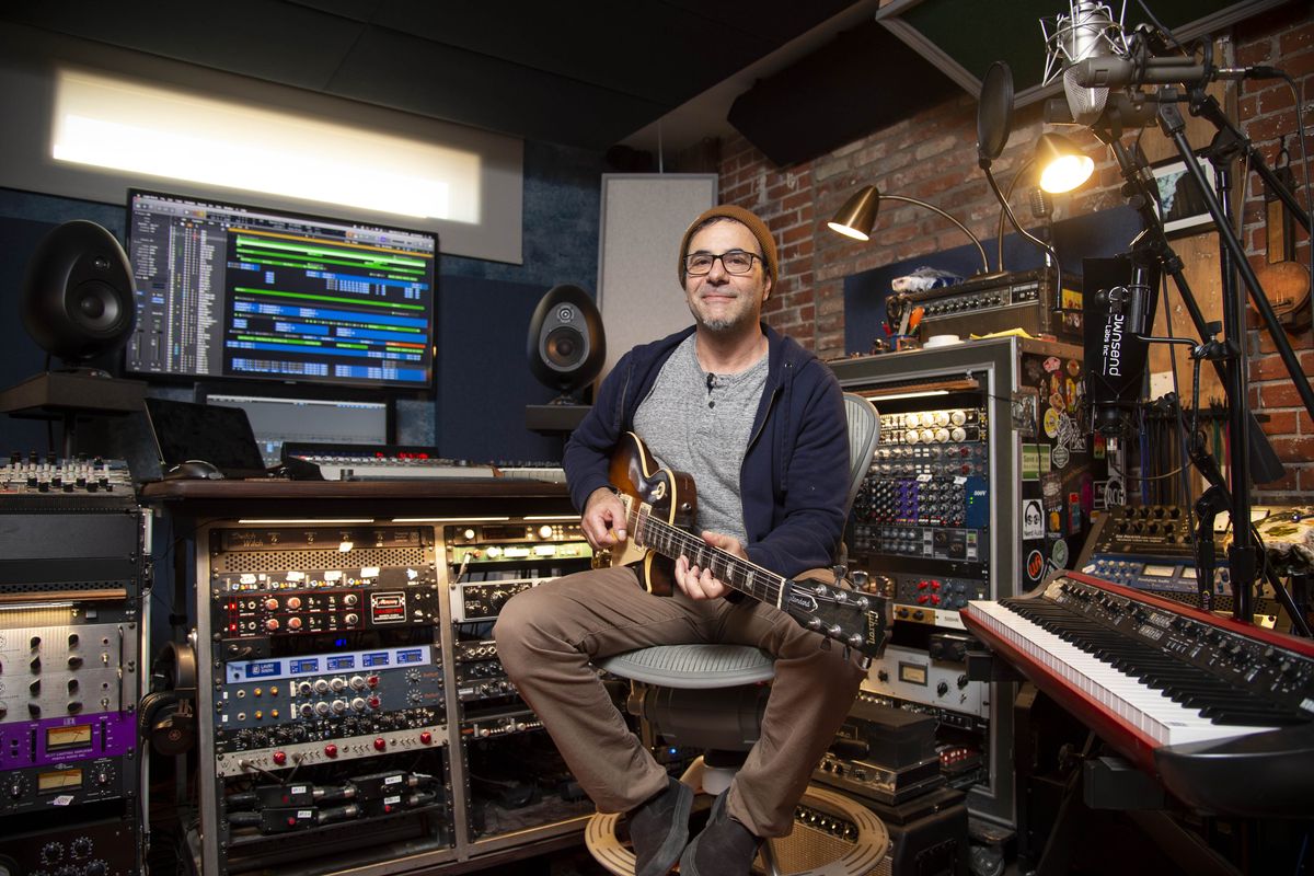 Composer, producer and guitarist Jay Condiotti sits in his recording studio, J Bones Musicland, in Spokane on Monday. He and his wife, Brooke, recently recorded their first EP, “Silver Smile,” in the pub-turned-studio space.  (Jesse Tinsley/The Spokesman-Review)