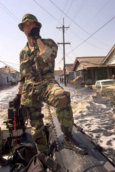 
Staff Sgt. Jason Geraden, an Army Ranger from Fort Bragg, Ga., patrols a flooded street Friday in New Orleans. Officials now estimate that predictions of catastrophic numbers of deaths may not materialize.
 (ZUMA Press / The Spokesman-Review)