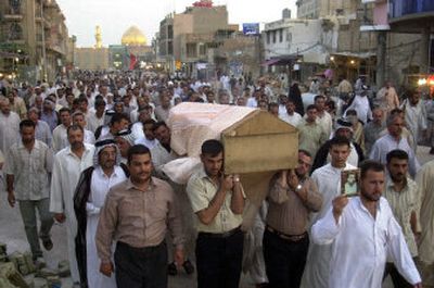 
The coffin of Ali Hussein, who was killed in a suicide bomber's attack on a military recruitment center in Baghdad on Wednesday, is returned to his hometown for funeral services in Najaf, Iraq, on Thursday.
 (Associated Press / The Spokesman-Review)