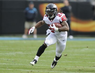 In this Dec. 24, 2016, file photo, Atlanta Falcons’ Devonta Freeman (24) runs against the Carolina Panthers in the first half of an NFL football game in Charlotte, N.C. The Atlanta Falcons have agreed to terms on a five-year contract extension with running back Devonta Freeman, addressing one of the biggest issues for the defending NFC champions. The deal was announced Wednesday, Aug. 9, 2017 on the eve of the team’s first preseason game at Miami. (Mike McCarn / Associated Press)