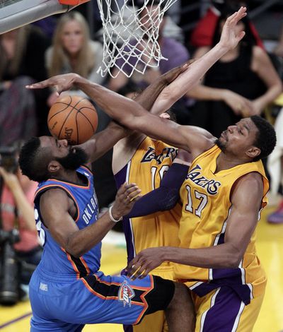 Oklahoma City’s James Harden, left, gets his shot blocked by Los Angeles’ Andrew Bynum during Game 4 on Sunday. (Associated Press)