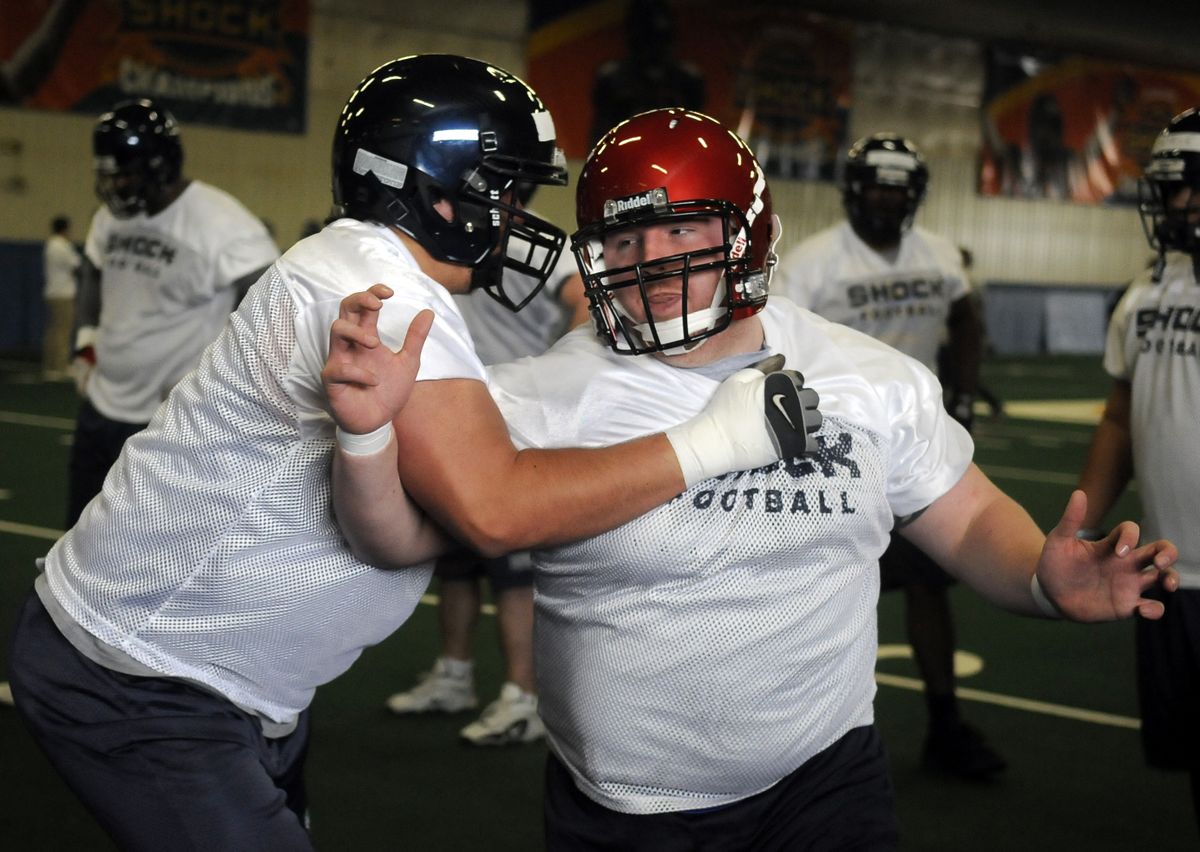 Matt Alfred, right, battles Bobby Byrd during practice on Tuesday.  (Dan Pelle / The Spokesman-Review)