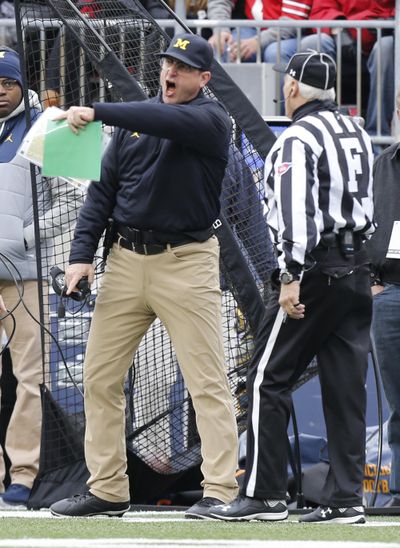 Michigan head coach Jim Harbaugh, left, yells at the field judge during the first half of an NCAA college football game against Ohio State, Saturday, Nov. 26, 2016, in Columbus, Ohio. Ohio State beat Michigan 30-27 in double overtime. (Jay LaPrete / Associated Press)