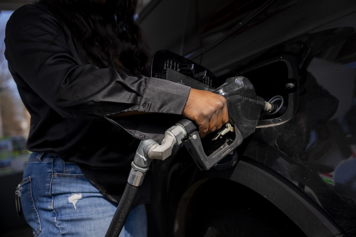 A driver fills up at a gas station on March 19 in Brooklyn. Higher fuel costs are raising food and travel prices while a shaky stock market tamps down free spenders. (VINCENT ALBAN)