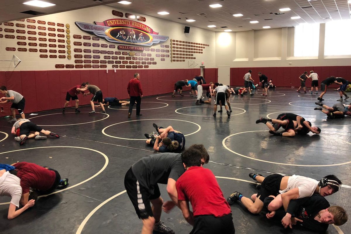 Coach Don Owen, center, looks over his wrestling team at practice at University High School on Wednesday. (Dave Nichols / The Spokesman-Review)