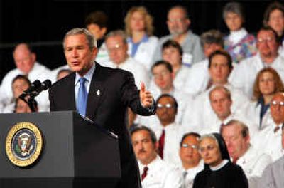 
With medical professionals on stage, President Bush delivers his remarks Wednesday in Collinsville, Ill. 
 (Associated Press / The Spokesman-Review)