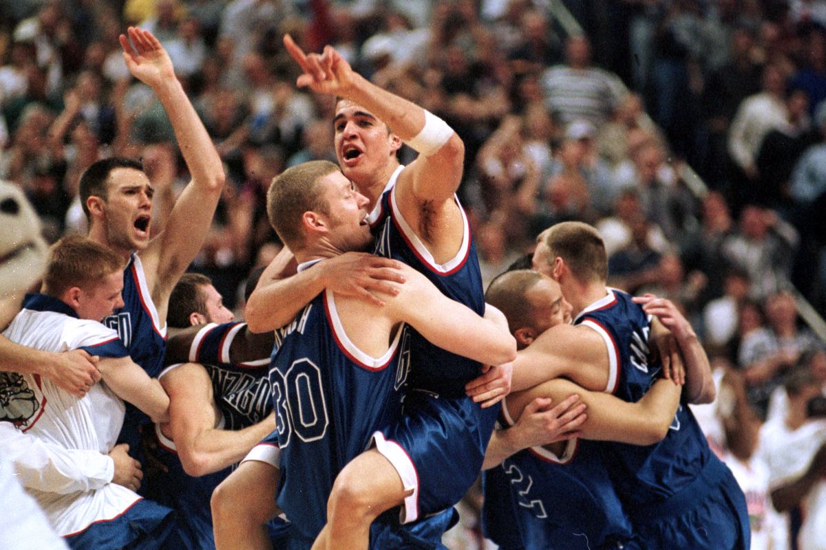 Then: Jeremy Eaton, Axel Dench (30), Richie Frahm, Mike Leasure, and Casey Calvary celebrate Gonzaga’s 73-72 win over Florida in the 1999 NCAA tournament. The win sent GU to the regional final, where the Zags lost to Connecticut. (Dan Pelle)