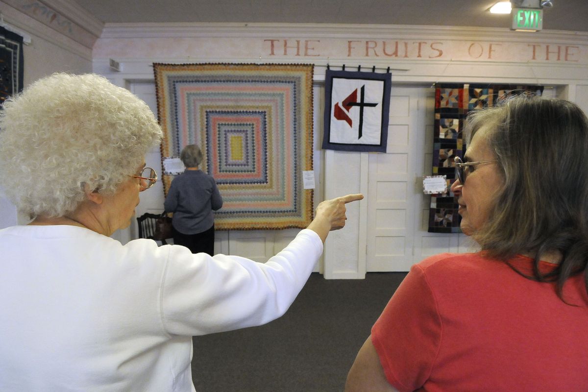 Julie Roberts, left, and Arlene Sheely attend a quilt show at Manito United Methodist Church’s centennial event Saturday in Spokane. (Dan Pelle / The Spokesman-Review)