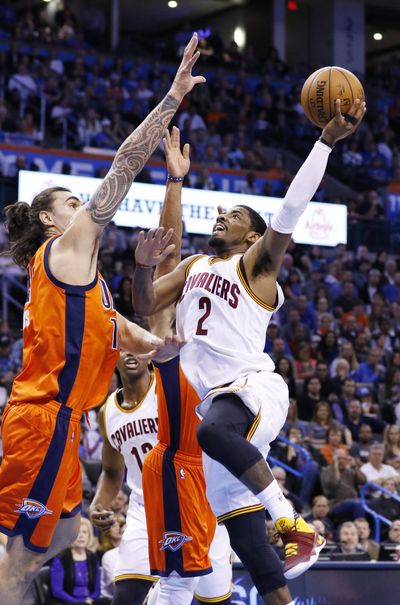FILE - In this Sunday, Feb. 21, 2016, file photo, Cleveland Cavaliers guard Kyrie Irving (2) goes up for a basket in front of Oklahoma City Thunder center Steven Adams (12) defends during the first half of an NBA basketball game in Oklahoma City. Turns out, Irving didn't have a flu bug. He had bed bugs. The star guard says he left Cleveland's game against Oklahoma City because he felt nauseous and tired from lack of sleep after being bitten in his hotel room. (AP Photo/Alonzo Adams, File) ORG XMIT: NY171 (Alonzo Adams / AP)