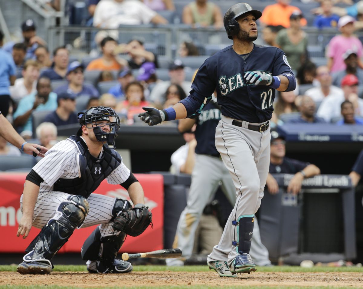 Seattle’s Robinson Cano and Yankees catcher Brian McCann watch the flight of Cano’s two-run homer in the sixth for a 4-2 lead. (Associated Press)