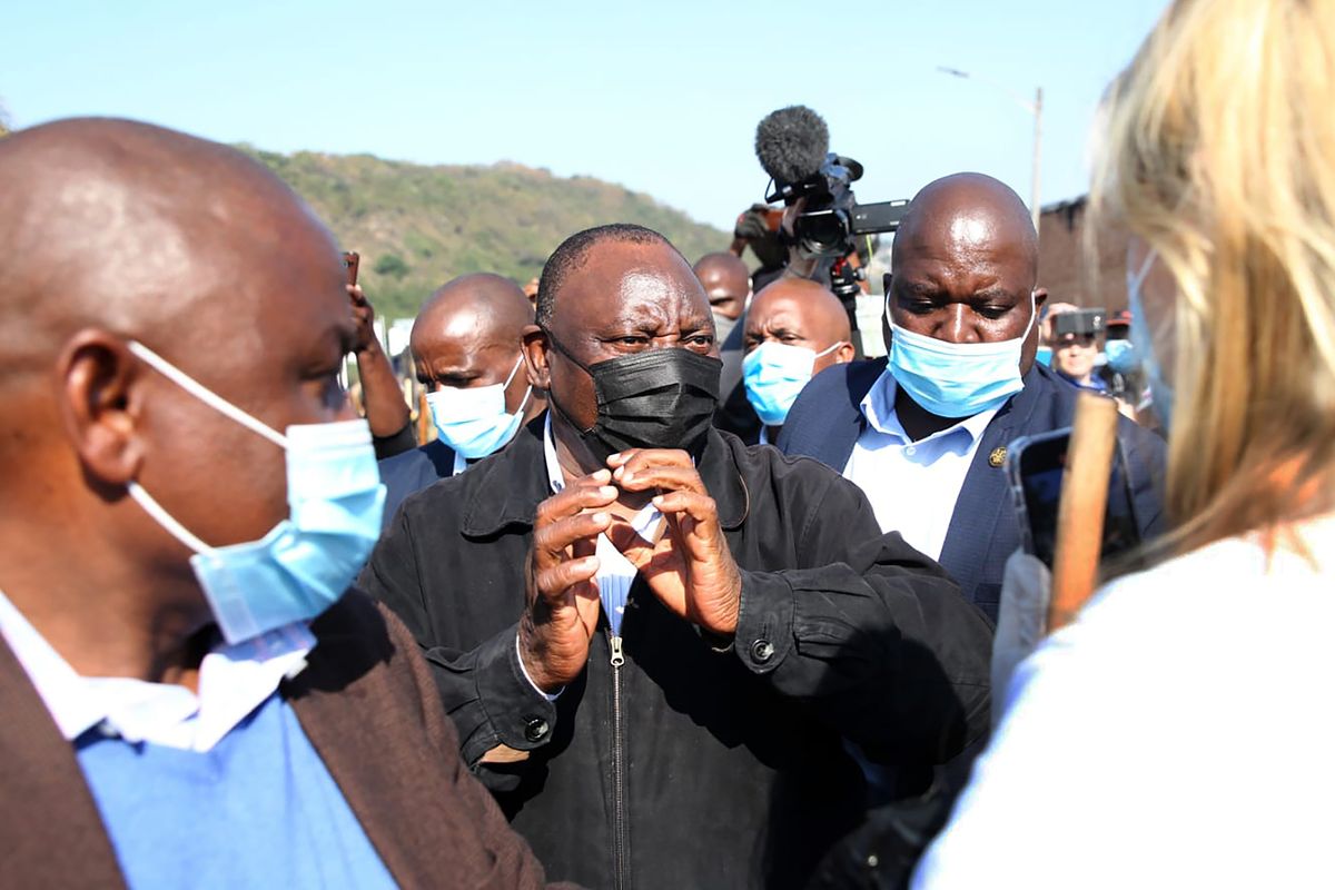 South African President Cyril Ramaphosa, visits an area in Durban, South Africa, Friday, July 16, 2021 which was badly affected by unrest in the past week. South Africa