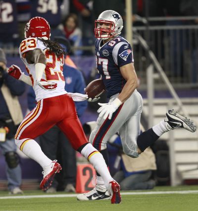 Rob Gronkowski races past the Chiefs’ Kendrick Lewis on one of the Patriots’ two touchdown receptions. (Associated Press)