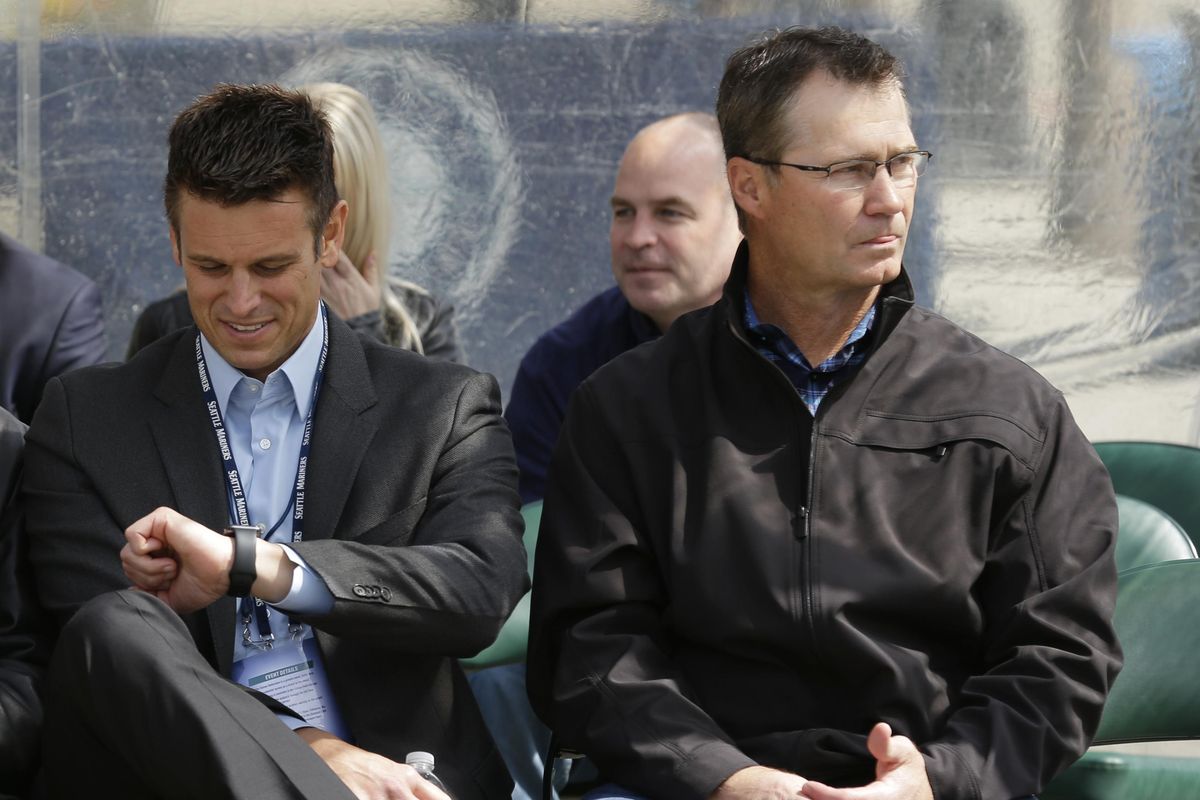Seattle Mariners general manager Jerry Dipoto, left, sits with manager Scott Servais during the unveiling of a statue of Mariners baseball legend Ken Griffey Jr., April 13, 2017, in front of Safeco Field in Seattle. (Ted S. Warren / AP)