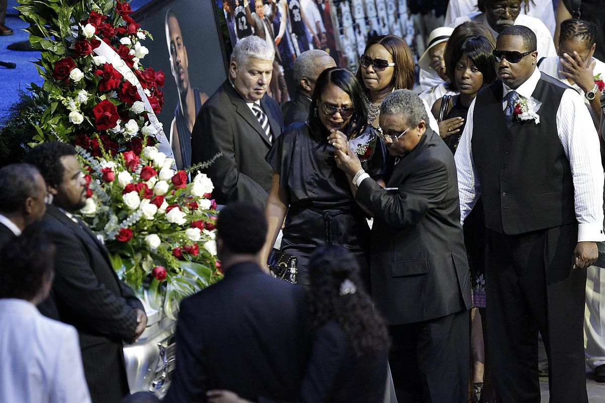 In this Aug. 4, 2010 photo, Sherra Wright, the ex-wife of slain NBA basketball player Lorenzen Wright, grieves at the casket of Lorenzen Wright during a memorial service at the FedExForum in Memphis, Tenn. (Lance Murphey / Associated Press)