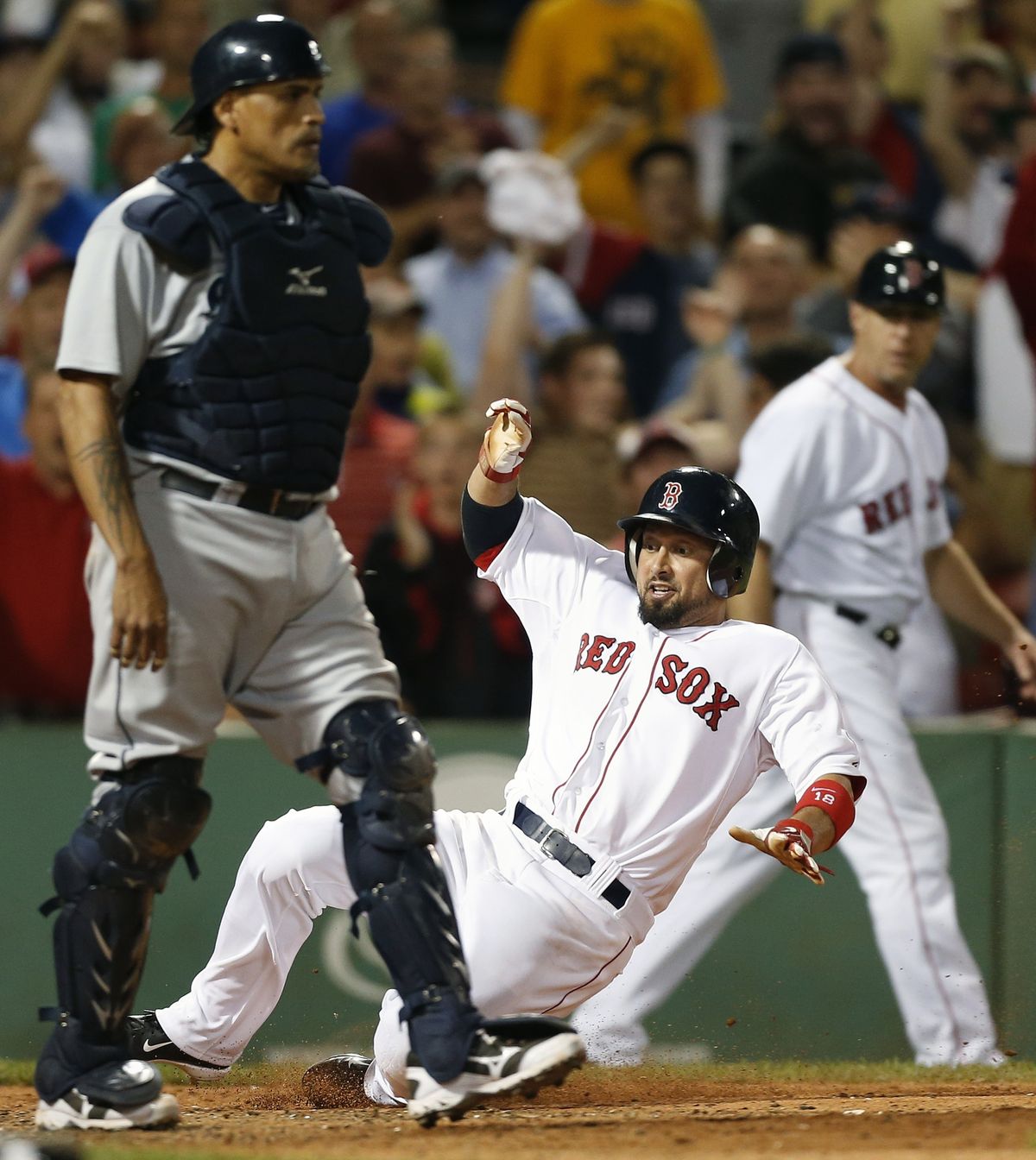 Boston Shane Victorino slides home with the tying run in the ninth inning. (Associated Press)