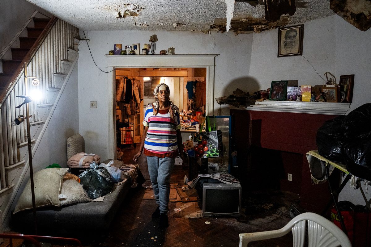 Bernadette Reese-Hobson in her living room at her Philadelphia home, which is desperately in need of repair from water damage. MUST CREDIT: Demetrius Freeman/The Washington Post  (Demetrius Freeman/The Washington Post)