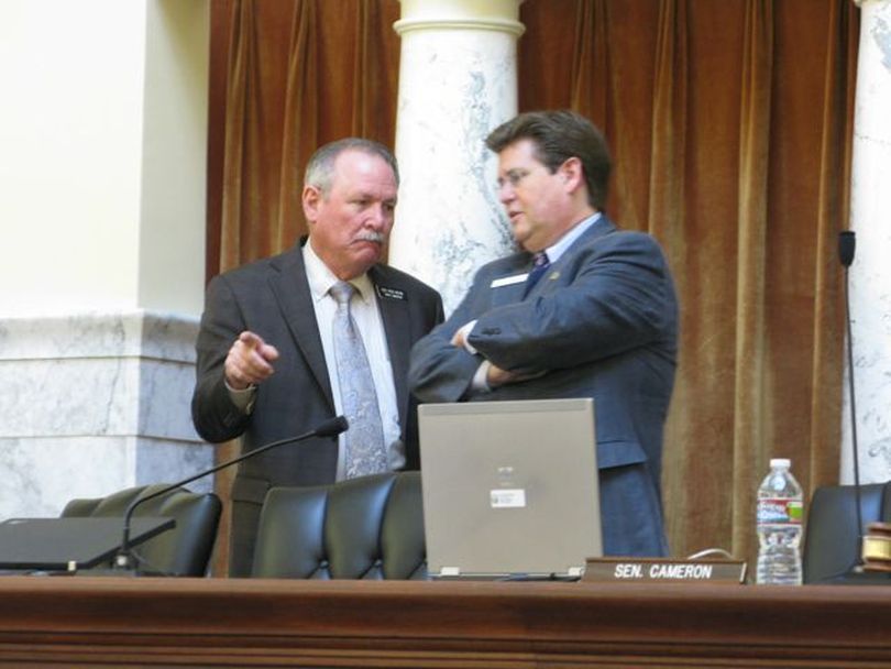 Rep. Fred Wood, R-Burley, left, talks with Senate Finance Chairman Dean Cameron, R-Rupert, before the start of a Joint Finance-Appropriations Committee meeting on Wednesday morning; Wood proposed adding back 10 positions at State Hospital South after more than 30 have been cut over the past three years, jeopardizing the mental hospital's accreditation and patient and staff safety. (Betsy Russell)