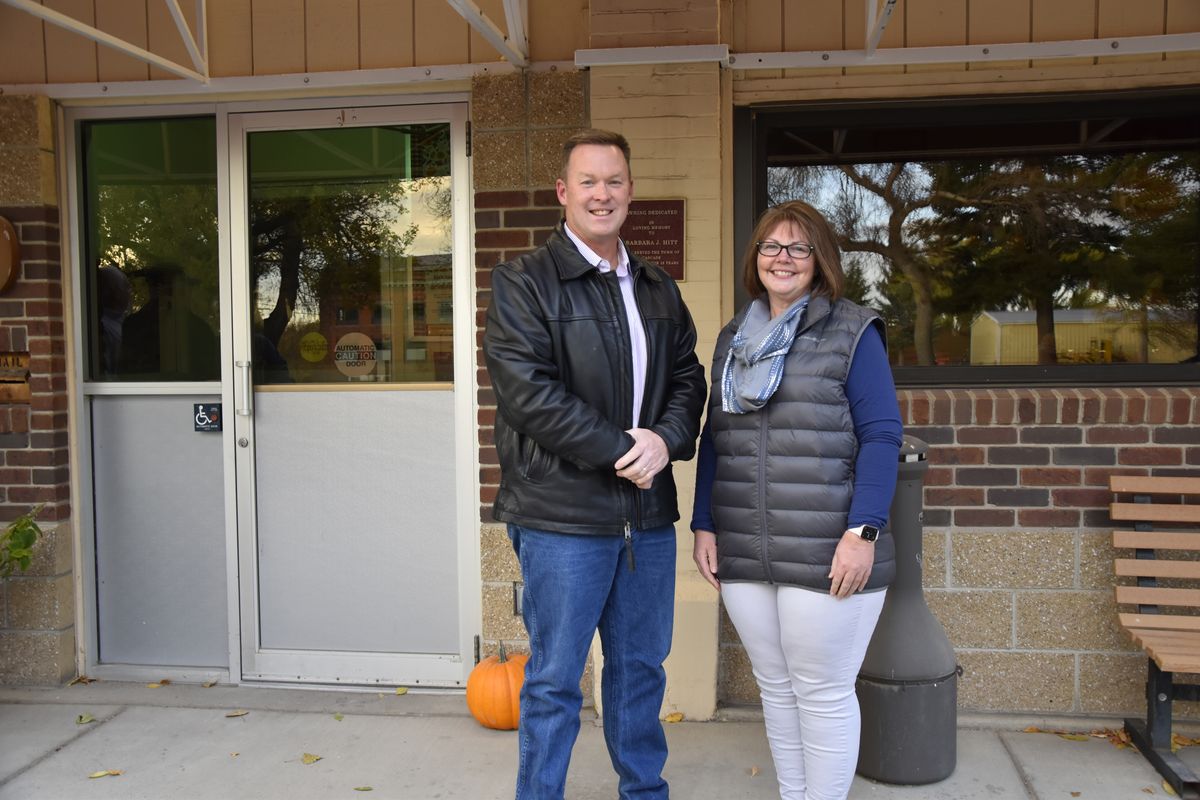 Ken and Kelly Speidel stand outside the community hall of Cascade, Mont., Friday, Oct. 15, 2021. The Speidels own a horse boarding business in Cascade, a rural community on the banks of the Missouri River. For the first time in 30 years, the Census has awarded Montana a second seat in Congress and a commission is being tasked with determining how to divide the state into two congressional districts.  (Iris Samuels)