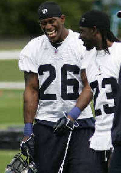
Ken Hamlin, left, and Marcus Trufant share a laugh during minicamp. 
 (Associated Press / The Spokesman-Review)