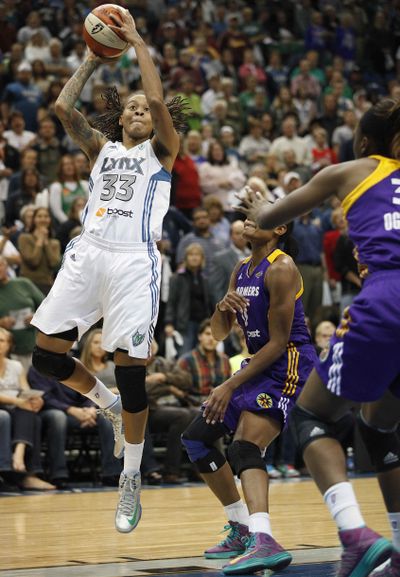 Minnesota Lynx guard Seimone Augustus (33) takes a shot over the Los Angeles Sparks defense. Augustus finished with 16 points. (Associated Press)