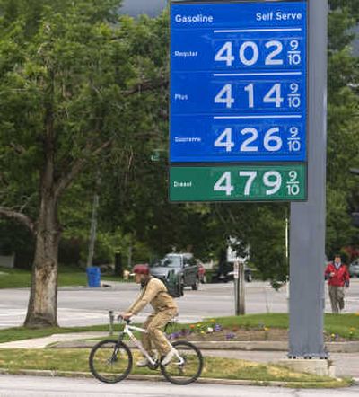 
A cyclist passes a Chevron gas sign in Salt Lake City.
 (The Spokesman-Review)