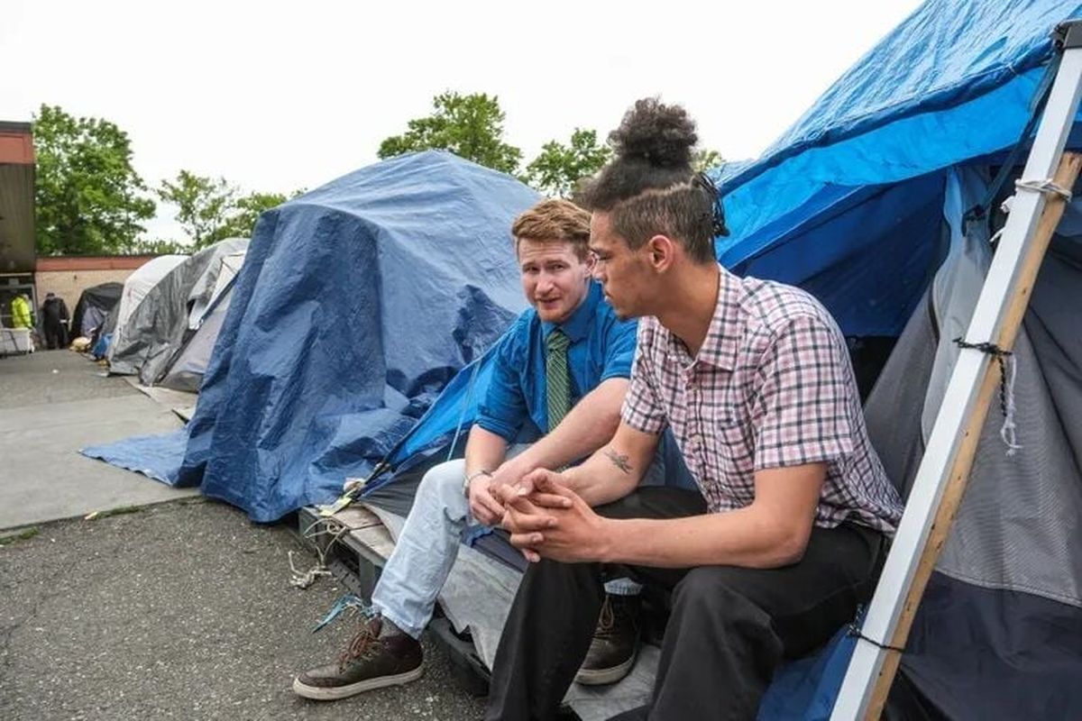 Justin Fain, left, and A.V. Royal are residents of Tent City 4, and subject to moving this weekend when the lease is up at the current location in Lake City.  (Dean Rutz/Seattle Times)