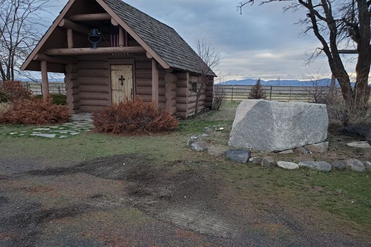 An empty rock slab sits outside the Roadside Chapel in Creston on Dec. 1, 2021. The statue of a praying cowboy was stolen from the slab sometime Tuesday morning, according to authorities.  (Copenhaver family)