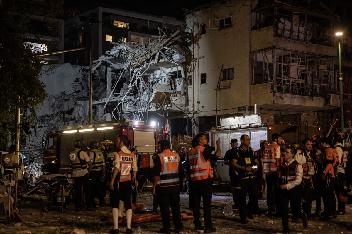 First responders at the scene of a residential building in Ramat Gan, Israel, that was heavily damaged by Iran’s barrage of ballistic missiles Friday. (Heidi Levine/For the Washington Post)