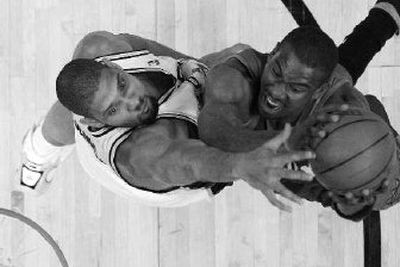 
San Antonio Spurs forward Tim Duncan, left, defends Phoenix Suns center Amare Stoudemire during the first half. 
 (Associated Press / The Spokesman-Review)