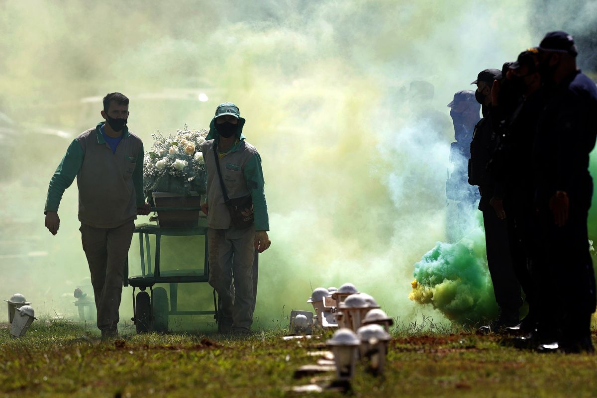Military policemen receive with full honors the arrival of the coffin that contains the remains of Sgt. Jorge Luis Pereira da Silva, 54, who died from COVID-19, at the Campo da Esperanca cemetery in Brasilia, Brazil, Tuesday, March 23, 2021. The nation had an average of 2,235 deaths a day last week – the highest since the beginning of the pandemic. (Eraldo Peres)