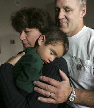 
Foster parents Angela and Steve Brandt hold Gabriel, 2, on Oct. 4. Associated Press
 (File Associated Press / The Spokesman-Review)