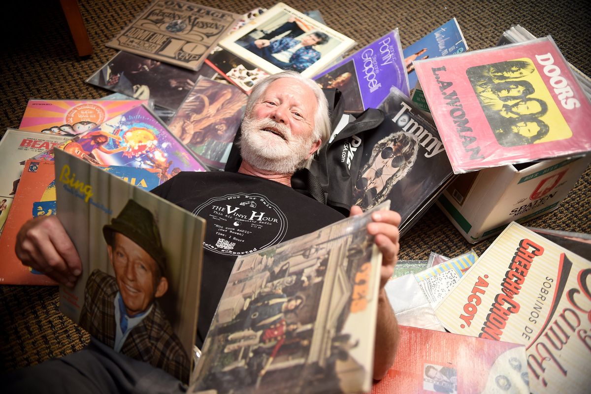 KYRS Programmer Ted Bowen is surrounded by albums for his “Vinyl Hour” radio and call-in show on Monday at the Community Building in downtown Spokane. Bowen has been producing the show for 19 years using his ecollection of albums that he hauls up several flights of stairs to the studio. The collection covers all ages and genres.  (Christopher Anderson/For The Spokesman-Review)