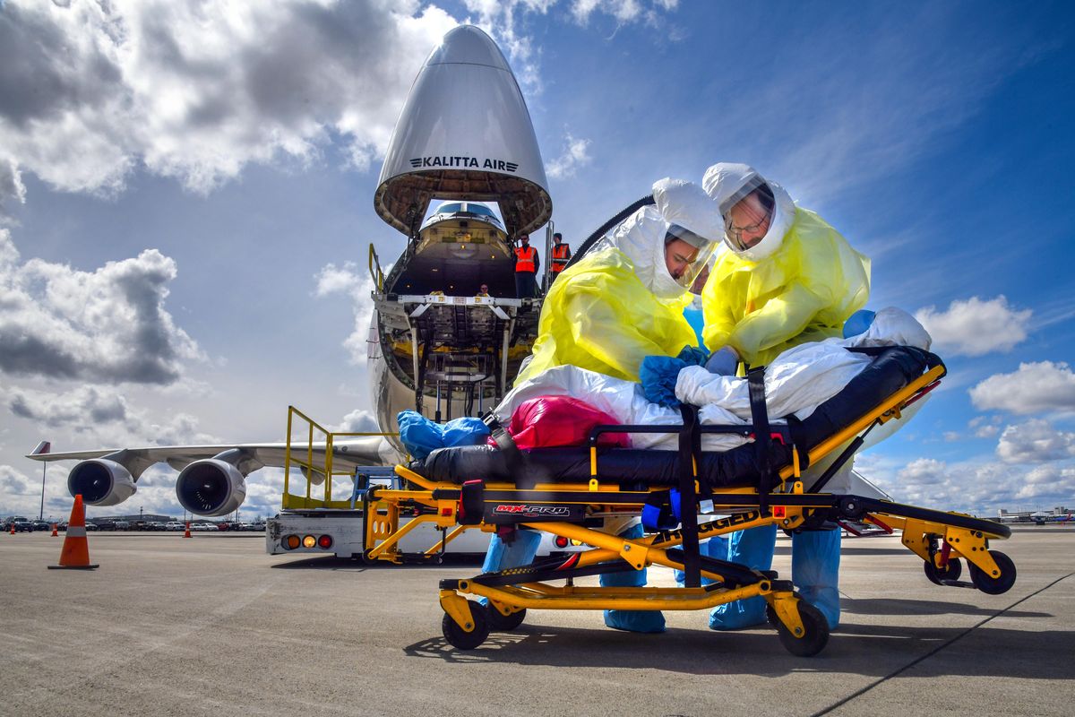 Team members attend to an mock Ebola patient during a federal exercise named Tranquil Terminus, April 11, 2018, at Spokane International Airport. Two patients arrived aboard a Boeing 747 cargo jet and transported to Sacred HeartÕs Special Pathogens Unit. (Dan Pelle / The Spokesman-Review)