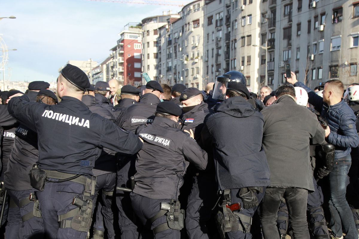 Serbian police officers and protesters clash during a protest in Belgrade, Serbia, Saturday, Nov. 27, 2021. Skirmishes on Saturday erupted in Serbia between police and anti-government demonstrators who blocked roads and bridges in the Balkan country in protest against new laws they say favor interests of foreign investors devastating the environment. (Milos Miskov)