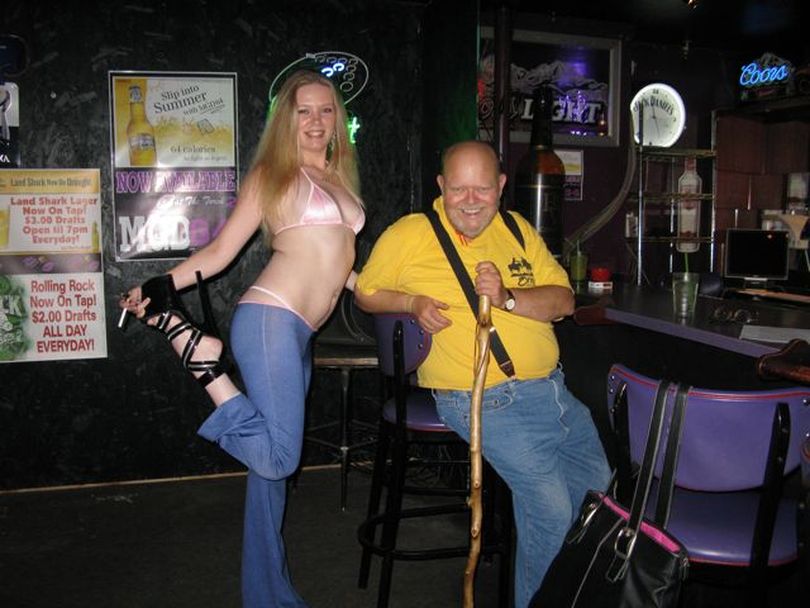 Tawni, a dancer at the Torch 2 bikini club in Boise, shows off her 8-inch stiletto heels as she joins Ron 