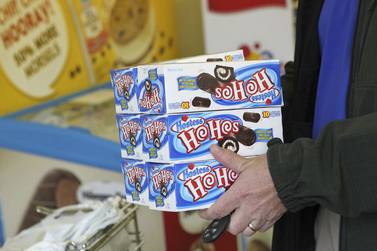 In this photo Friday, Nov. 16, 2012, Dan Curry, the superintendent of Liberty Christian in buys HoHos, at the Hostess Outlet store in Redding, Calif., shortly after it was announced Hostess was going out of business. "This is how I keep my office staff happy," Curry said. "So I