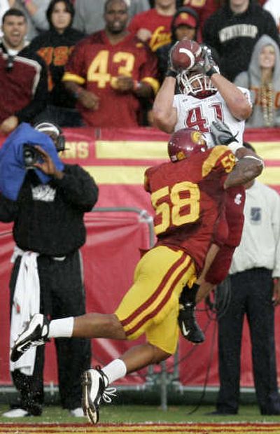 
WSU's Jed Collins hauls in a first-half touchdown pass against Rey Maualuga. Associated Press
 (Associated Press / The Spokesman-Review)