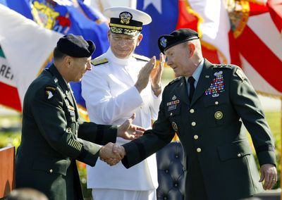 New head of the U.S. Central Command, U.S. Army Gen. David Petraeus, left, shakes hands with outgoing head U.S. Army Lt. Gen. Martin Dempsey at MacDill Air Force Base on Friday. (Associated Press / The Spokesman-Review)