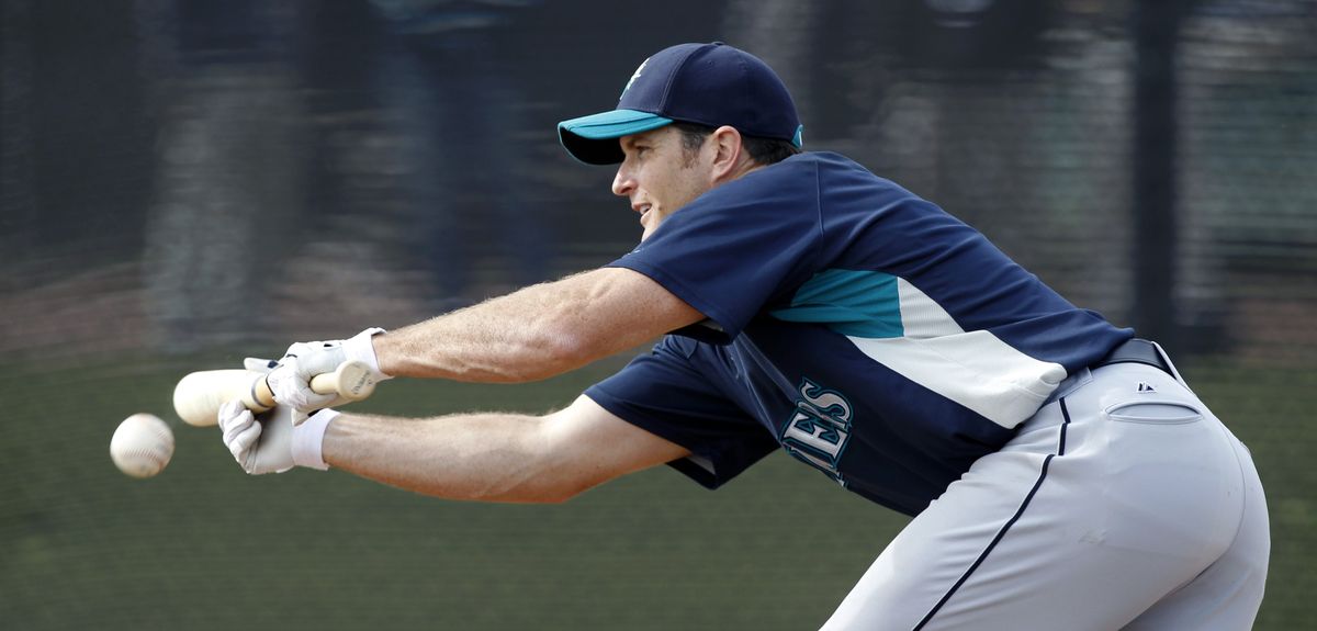 Sweeney, working on his bunting during a spring training workout Tuesday, arrived at camp feeling strong and injury-free.  (Associated Press)