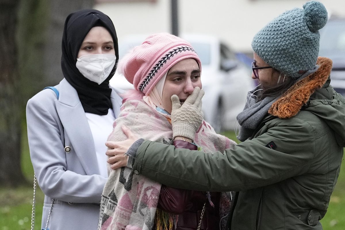 Syrian women Yasemine, center, who lost her father and brother in Syria, reacts after the verdict in front of the court in Koblenz, Germany, Thursday, Jan. 13, 2022. A German court has convicted a former Syrian secret police officer of crimes against humanity for overseeing the abuse of detainees at a jail near Damascus a decade ago. The verdict Thursday in the landmark trial has been keenly anticipated by Syrians who suffered abuse or lost relatives in the country’s long-running conflict.  (Martin Meissner)
