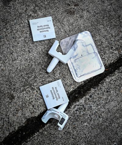 Narcan nasal spray containers litter the parking lot of the 7-11 at Second Avenue and Division Street. Narcan, or naloxone, is used in opioid emergencies, such as fentanyl overdoes common in the area.  (COLIN MULVANY/THE SPOKESMAN-REVIEW)