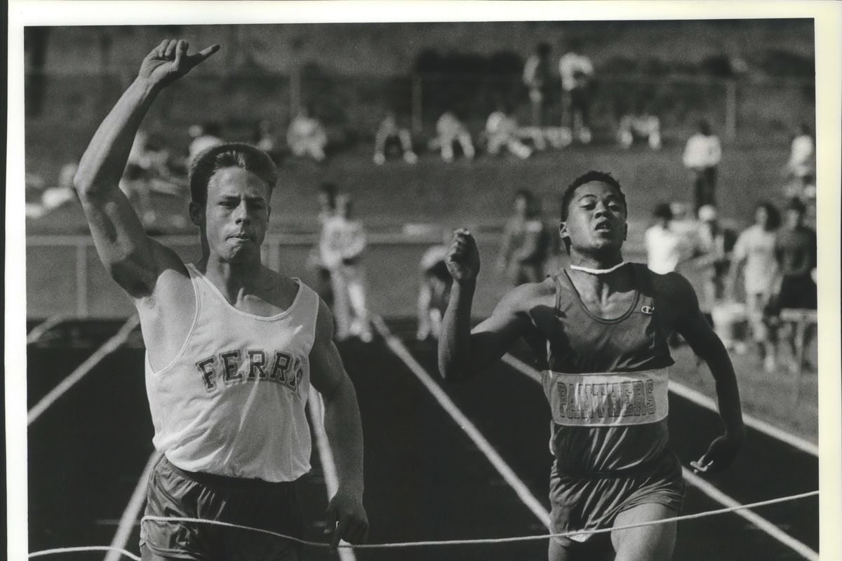 Clint Morton, left, and Kevin Kincaid cross the finish line int he 100-meter dash at the 1990 Greater Spokane League Championship.   (Cowles Publishing)