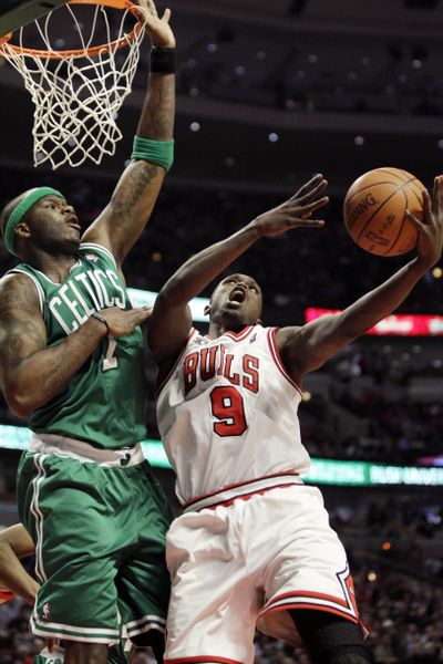 Chicago’s Luol Deng drives to the basket against Boston’s Jermaine O’Neal during Thursday’s home win for the Bulls. (Associated Press)