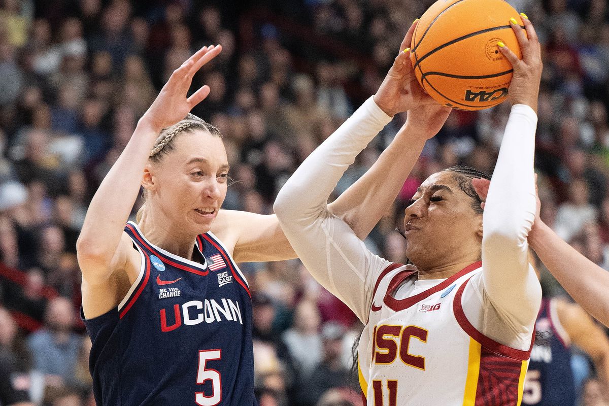 USC guard Kennedy Smith (11) heads to the basket as UConn guard Paige Bueckers (5) defends during first half of a Spokane Regional 1 Elite 8 NCAA women’s basketball game, Monday, March 31, 2025, in the Spokane Arena. (COLIN MULVANY)